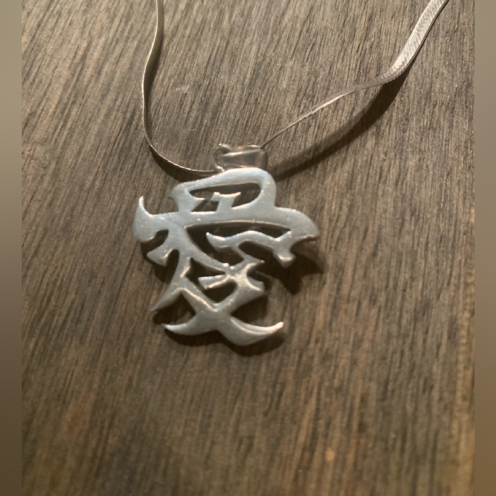 Sterling Silver “Love” pendant and chain.